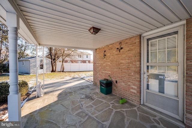 view of patio featuring a shed