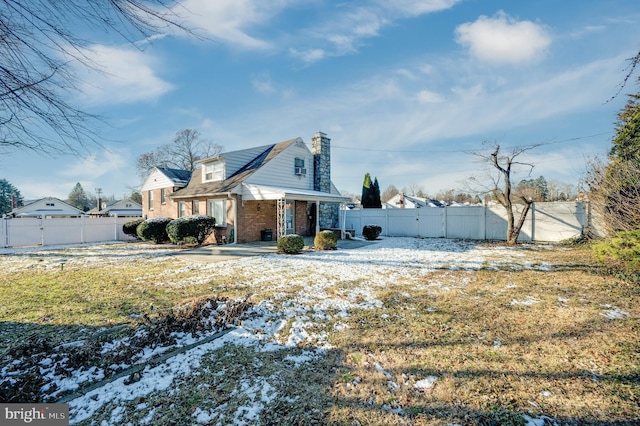 view of snowy exterior with a yard