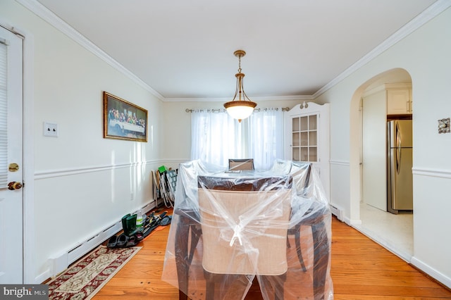 dining area with light hardwood / wood-style flooring, baseboard heating, and ornamental molding