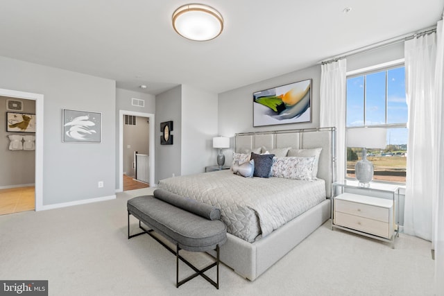 carpeted bedroom featuring ensuite bath