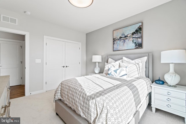 bedroom featuring light carpet and a closet