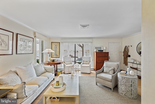 living room featuring light hardwood / wood-style flooring and ornamental molding