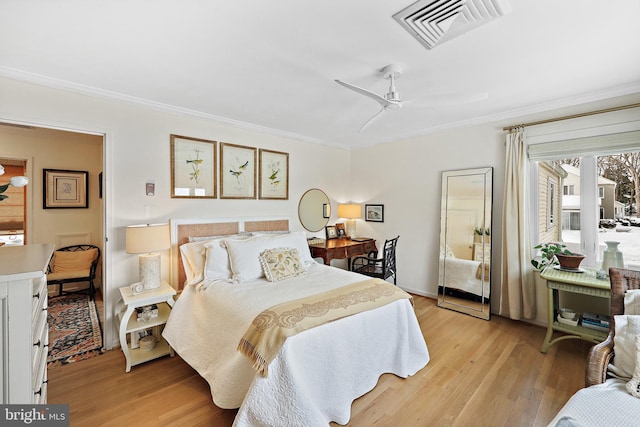 bedroom with ceiling fan, light wood-type flooring, and crown molding