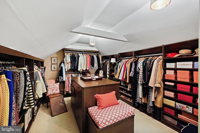 walk in closet featuring light colored carpet and lofted ceiling