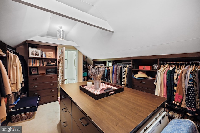 spacious closet with light colored carpet and lofted ceiling