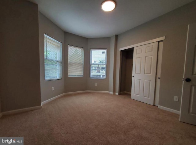 unfurnished bedroom with light colored carpet