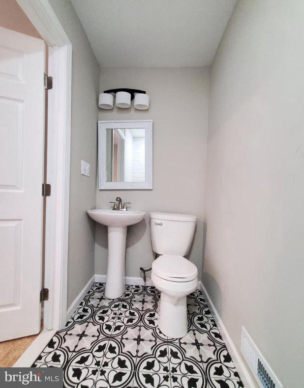 bathroom featuring tile patterned flooring and toilet