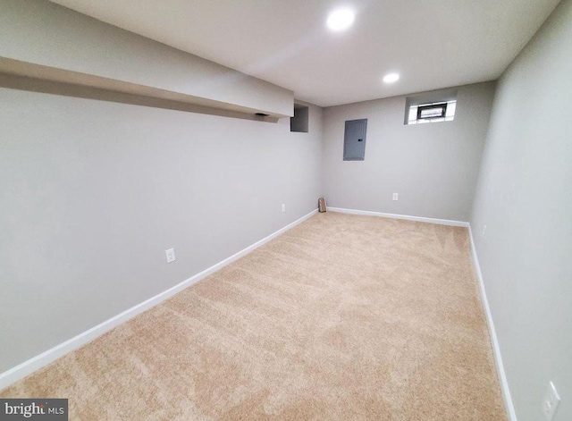 basement with electric panel and light colored carpet