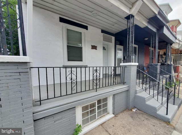 view of exterior entry featuring a porch