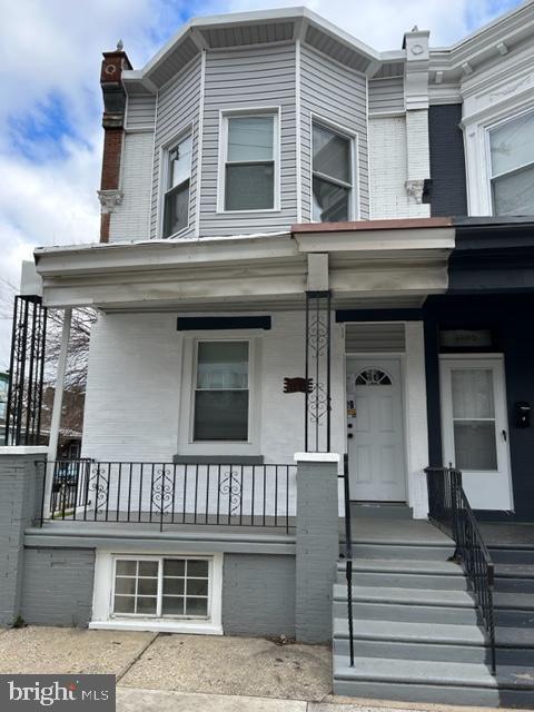 view of exterior entry with a porch