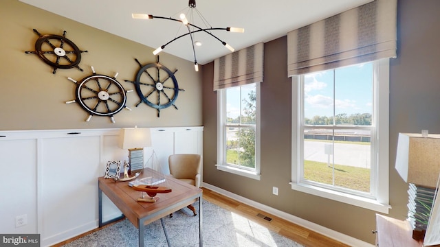 office space with a chandelier and light hardwood / wood-style floors