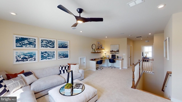 living room with ceiling fan and light colored carpet