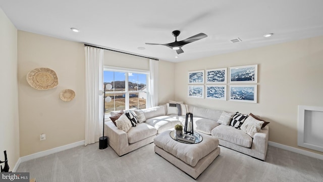 living room featuring light carpet and ceiling fan