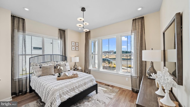 bedroom with hardwood / wood-style flooring