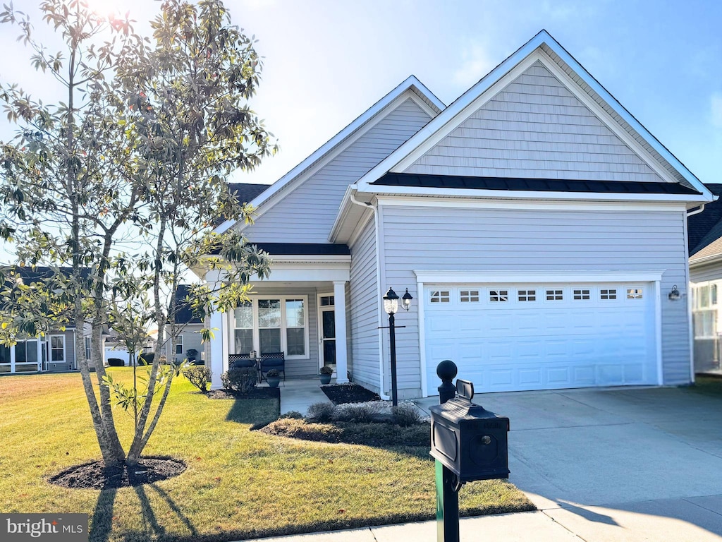 view of front of house with a front yard and a garage