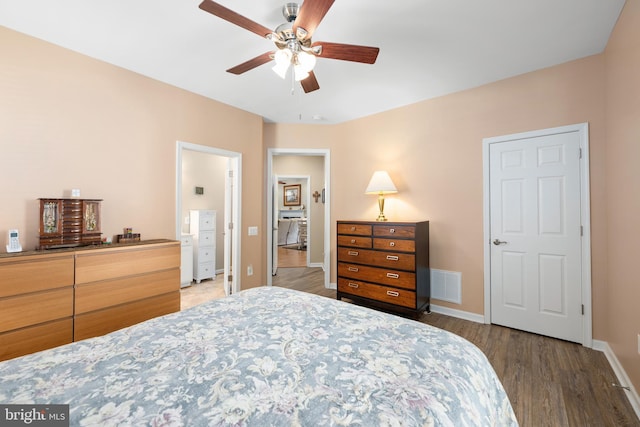 bedroom with dark hardwood / wood-style floors and ceiling fan