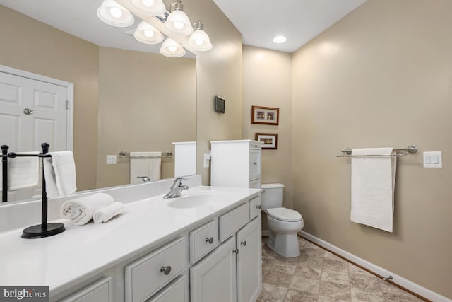 bathroom featuring vanity and toilet