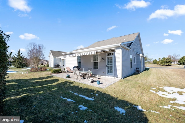 back of property with a patio and a lawn