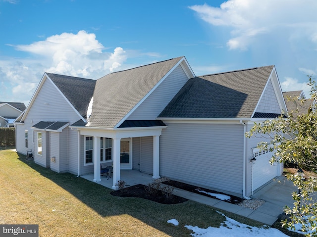 exterior space with a patio, a front yard, and a garage