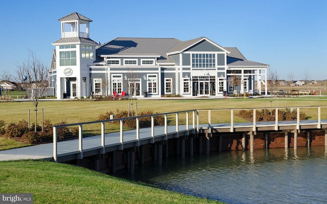 dock area featuring a lawn and a water view