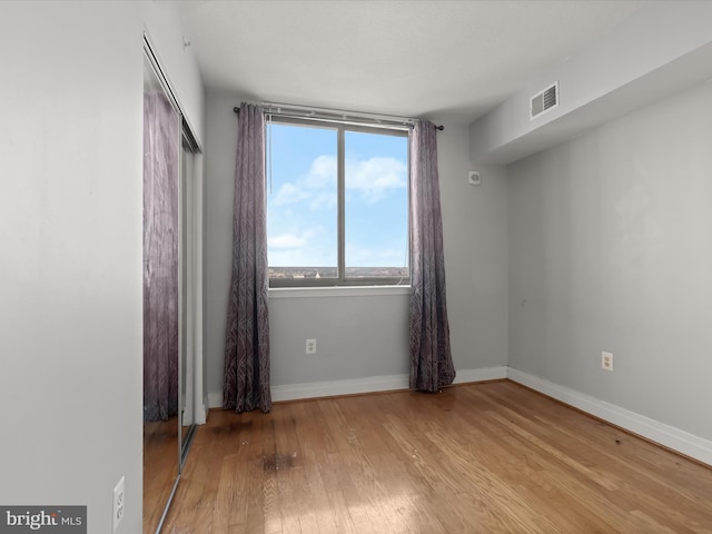 spare room with light hardwood / wood-style flooring