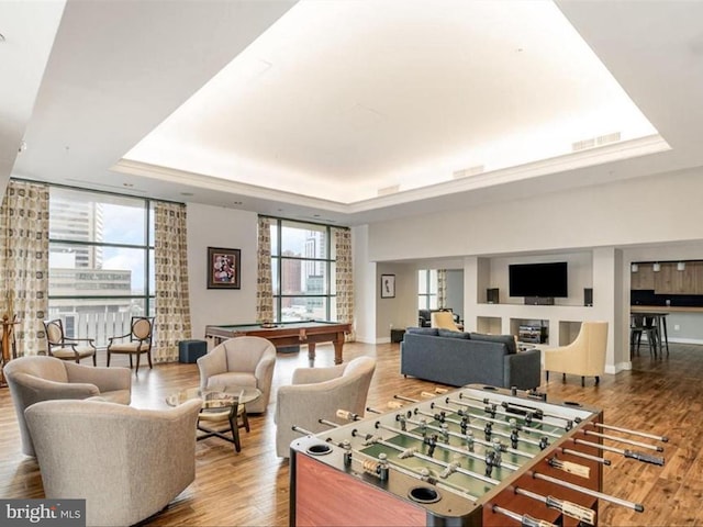 playroom with a raised ceiling, hardwood / wood-style flooring, and pool table