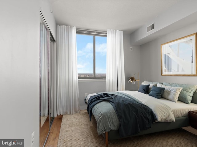 bedroom with hardwood / wood-style floors