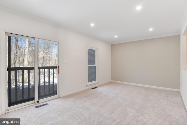 unfurnished room with light colored carpet and crown molding