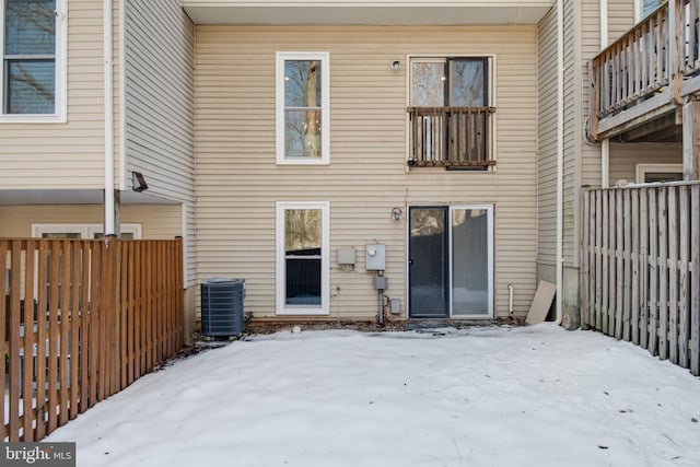 snow covered property with cooling unit