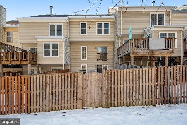 view of snow covered rear of property