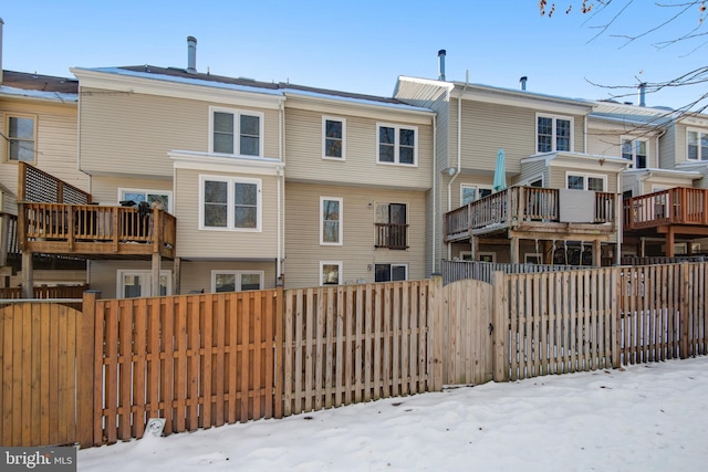 view of snow covered rear of property