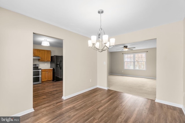 interior space featuring a notable chandelier, baseboards, and dark wood-type flooring