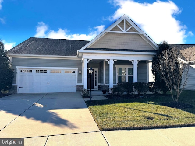 craftsman inspired home with a front yard and a garage