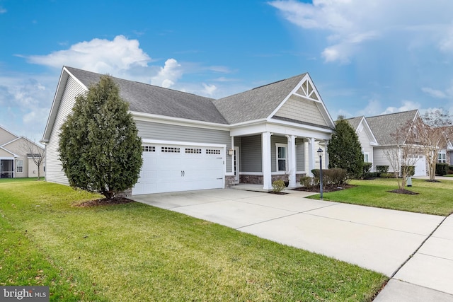 view of front facade featuring a porch, a front yard, and a garage