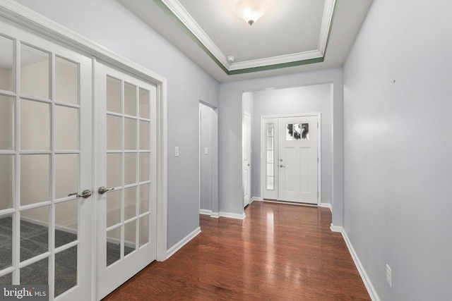 doorway with dark hardwood / wood-style floors, french doors, crown molding, and a tray ceiling