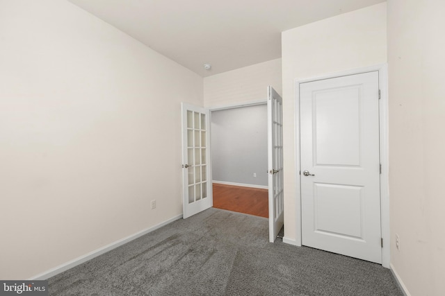 unfurnished bedroom featuring dark carpet