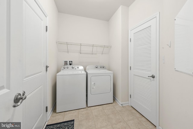 clothes washing area with washing machine and clothes dryer