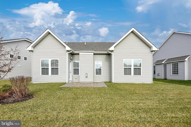 back of property with a patio area and a lawn