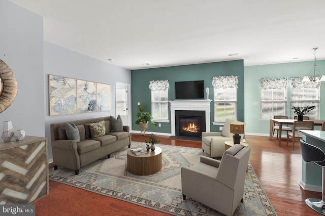 living room with wood-type flooring and a notable chandelier