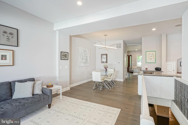 living room featuring an inviting chandelier and light hardwood / wood-style flooring