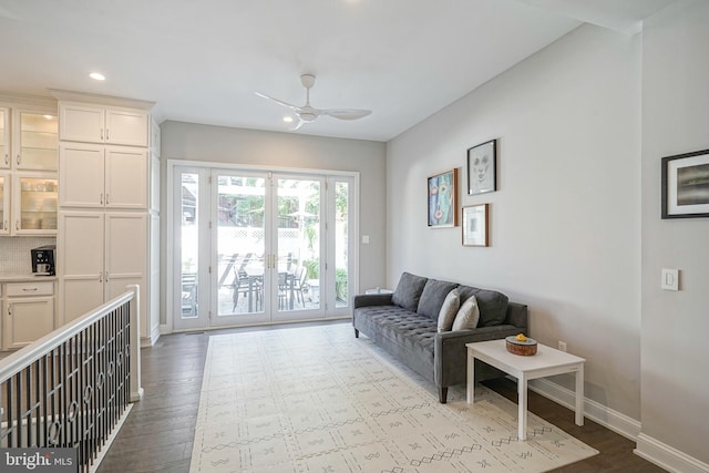 living room featuring ceiling fan and light hardwood / wood-style floors