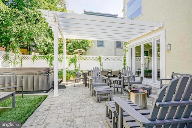 view of patio / terrace featuring a pergola and a hot tub