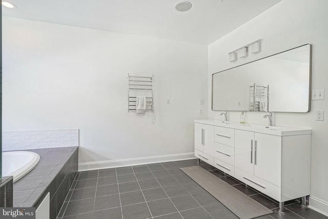 bathroom with tile patterned flooring, vanity, a relaxing tiled tub, and radiator heating unit