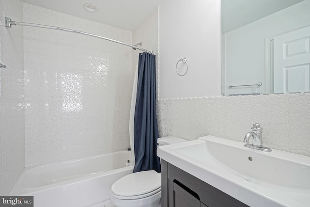 full bathroom featuring vanity, shower / bath combination with curtain, and toilet