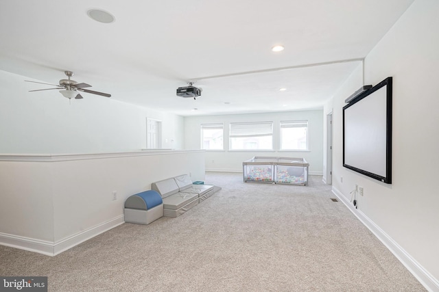 interior space featuring ceiling fan and carpet floors