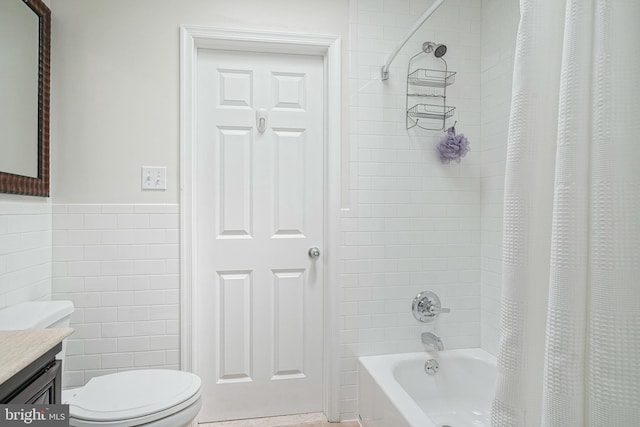 full bathroom with toilet, vanity, shower / tub combo with curtain, and tile walls