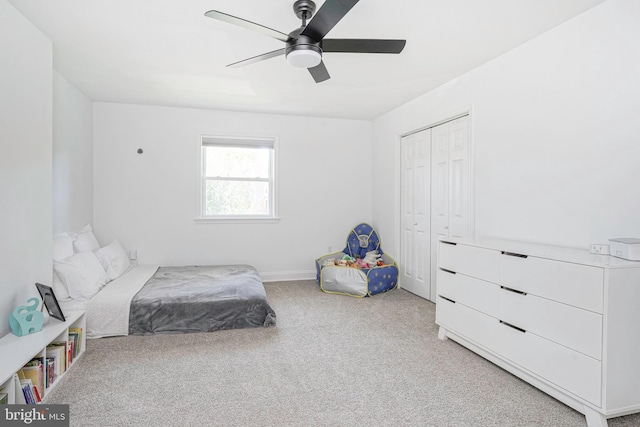 carpeted bedroom featuring a closet and ceiling fan