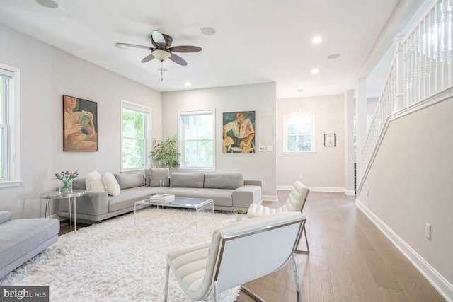 living room featuring light hardwood / wood-style floors and ceiling fan