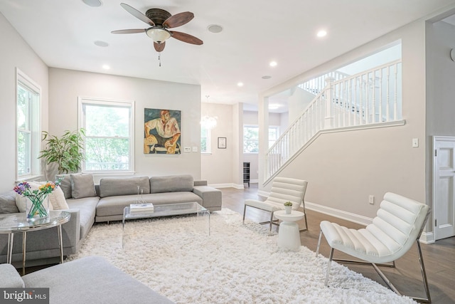 living room featuring hardwood / wood-style floors and ceiling fan