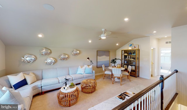 living room with ceiling fan, carpet floors, and vaulted ceiling